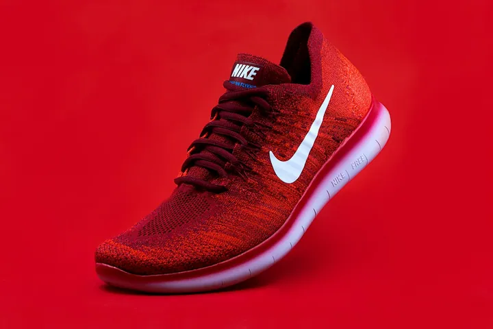 Red Nike running shoe in a sample footwear online store design